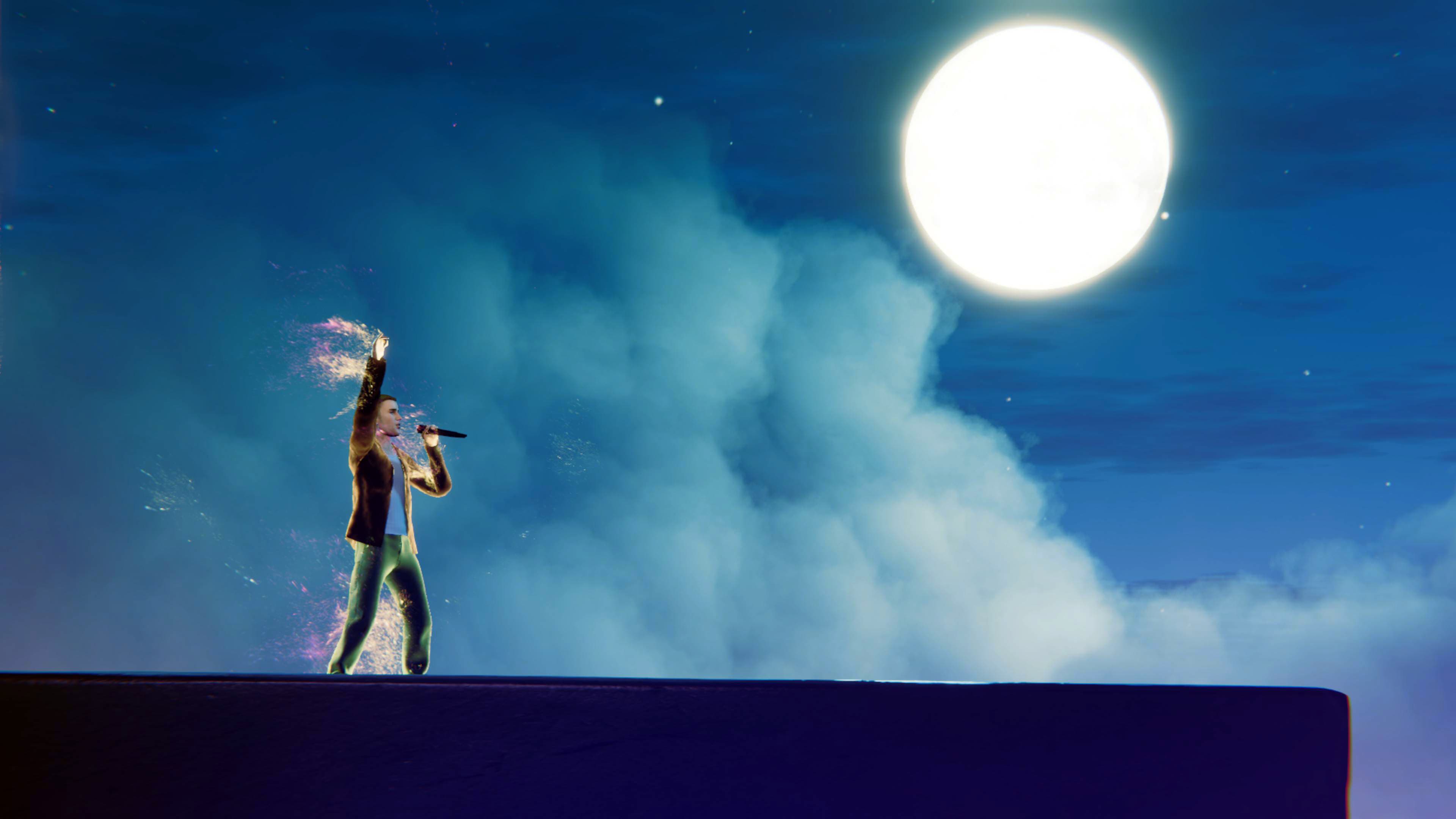 Justin Bieber performing against blue sky with clouds